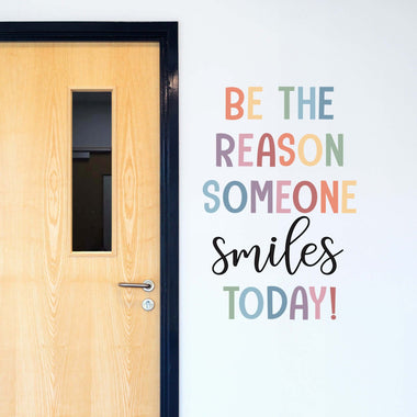 Be the reason someone smiles today! decal quote in a muted rainbow color scheme.